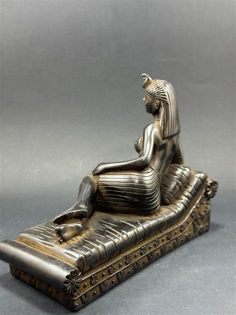 Cleopatra lying partly naked on a bed